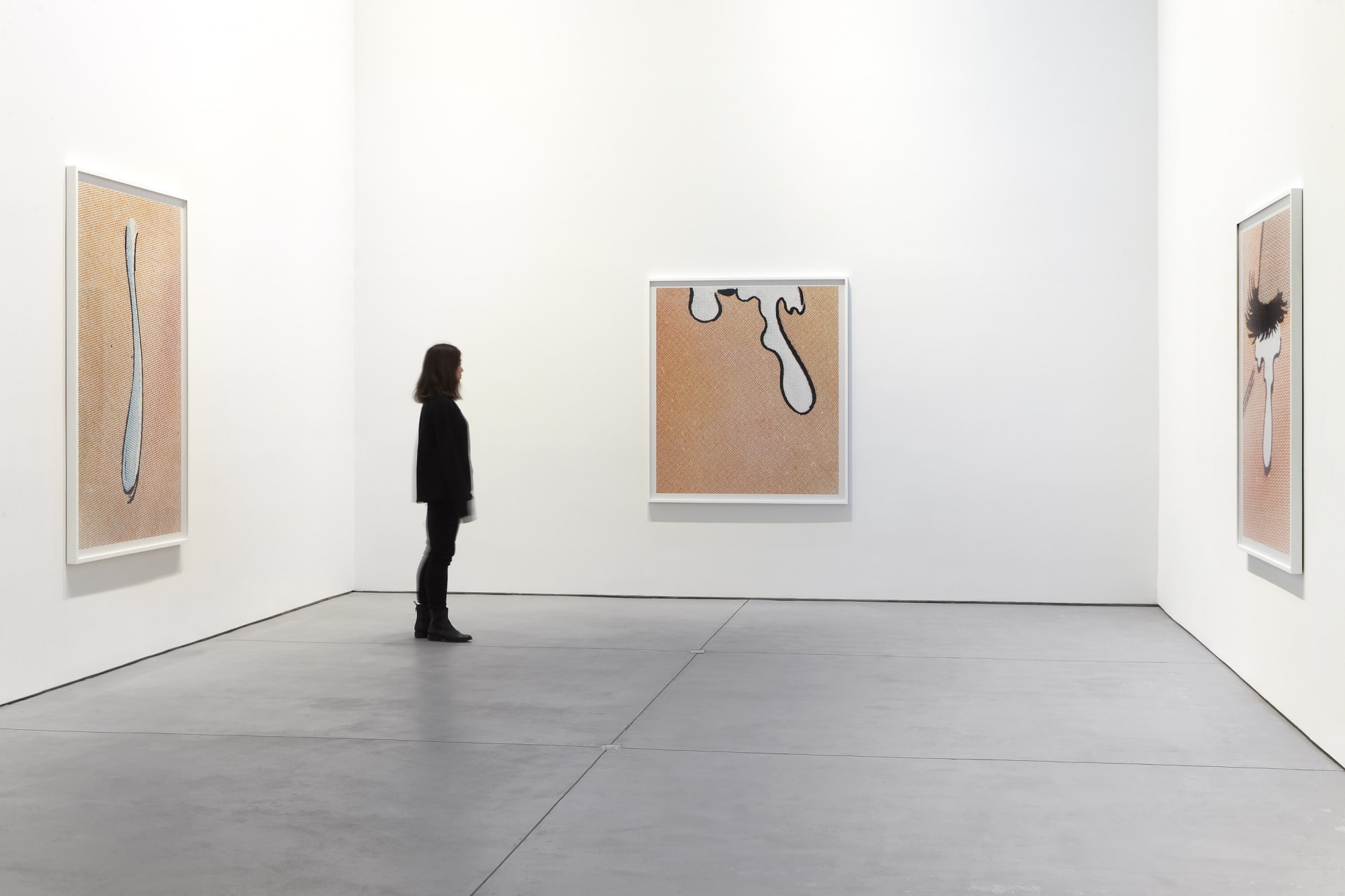 Installation view of Anne Collier's show. Onlooker views Tear (Comic).