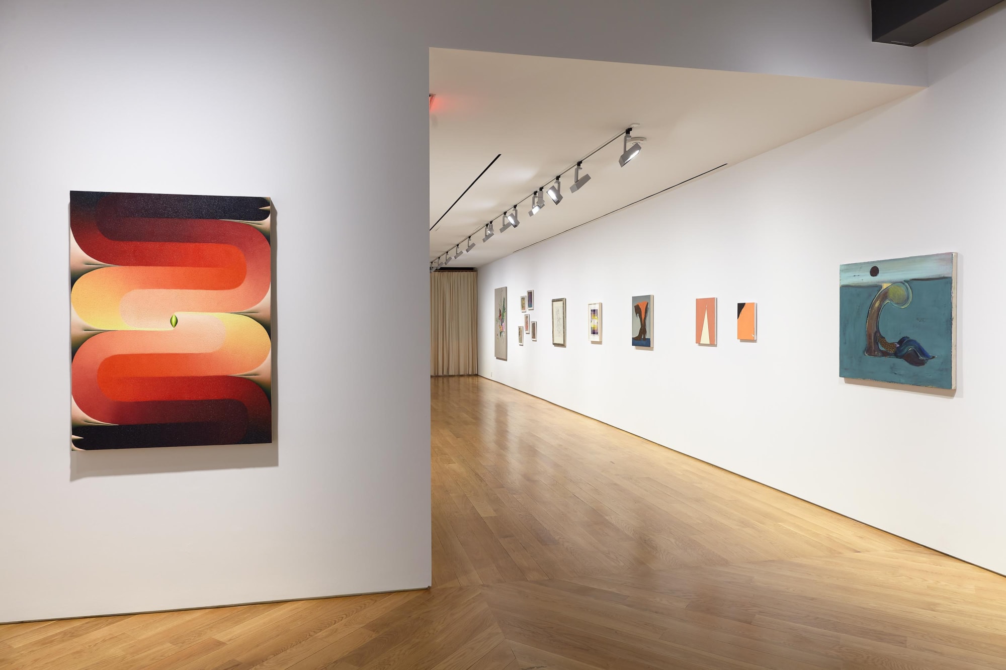 Installation view of 10 Exhibition, featuring Loie Hollowell's work Stacked Lingam in red, yellow, purple along with some other works.