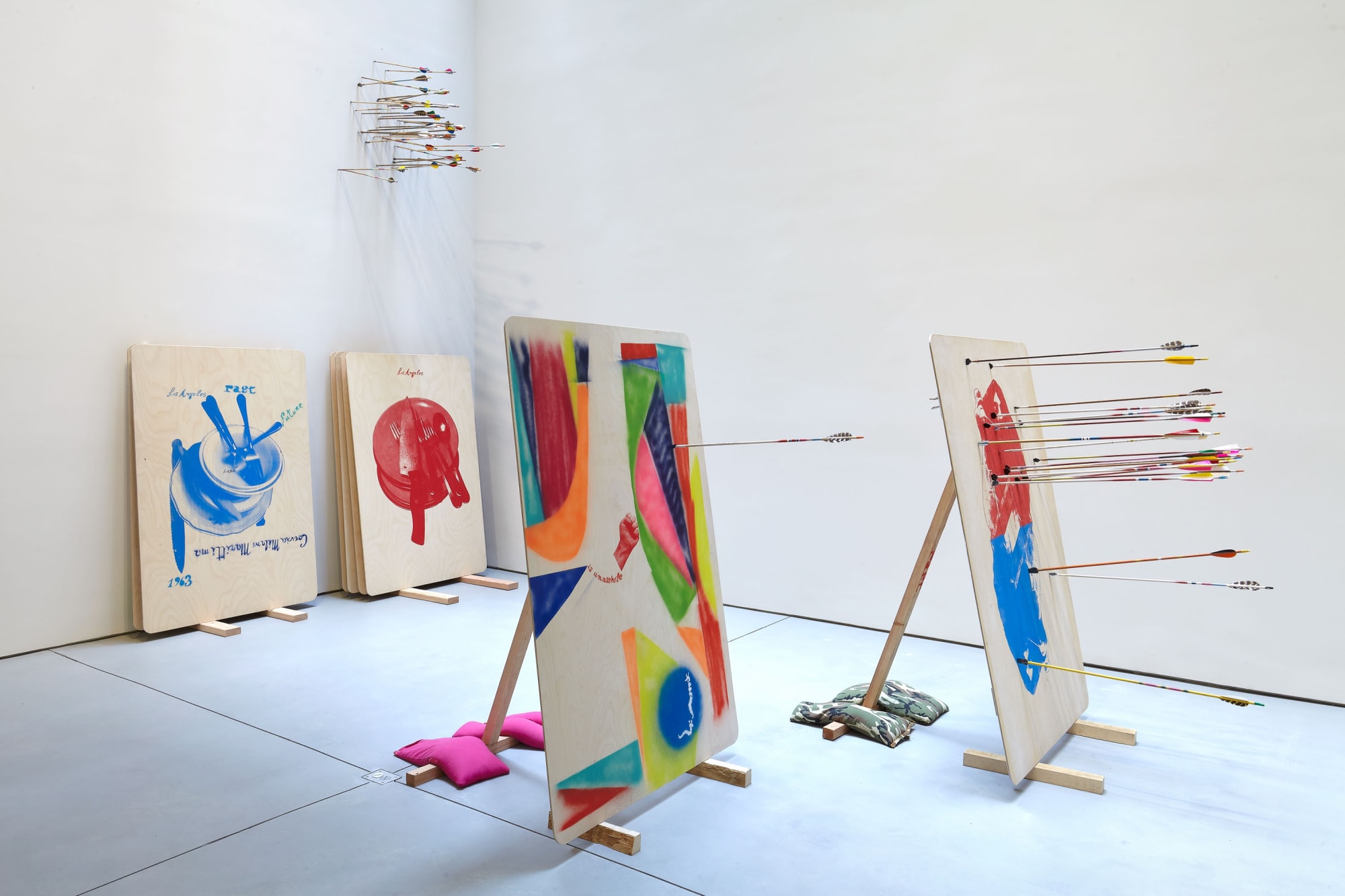 Installation view of Alessandro Pessoli's show Against Me. Painted works shown on the floor like firing range targets.