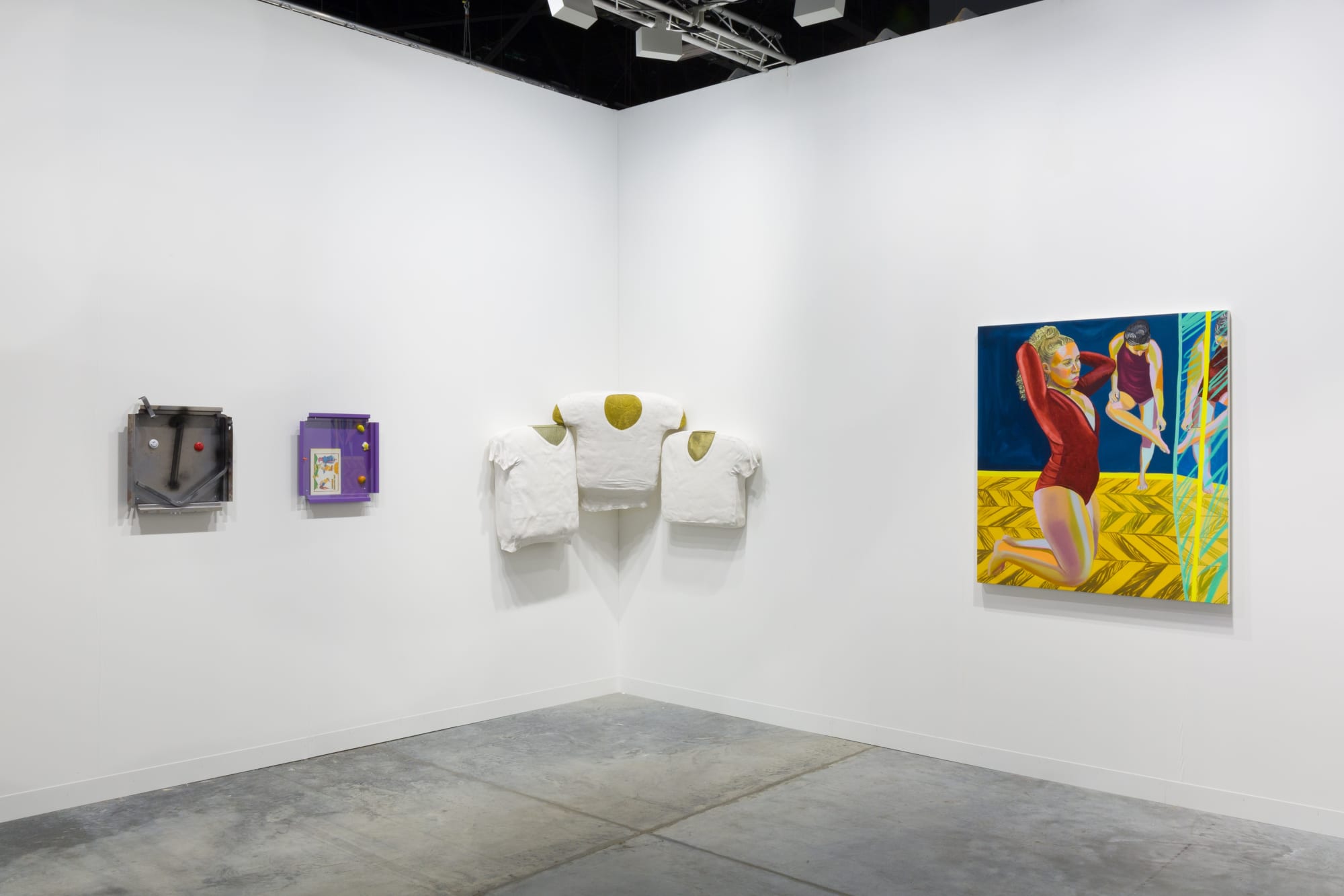 Installation views at Art Basel Miami Beach featuring paintings, sculptures, and more. Walls are white and works of art are colorful.