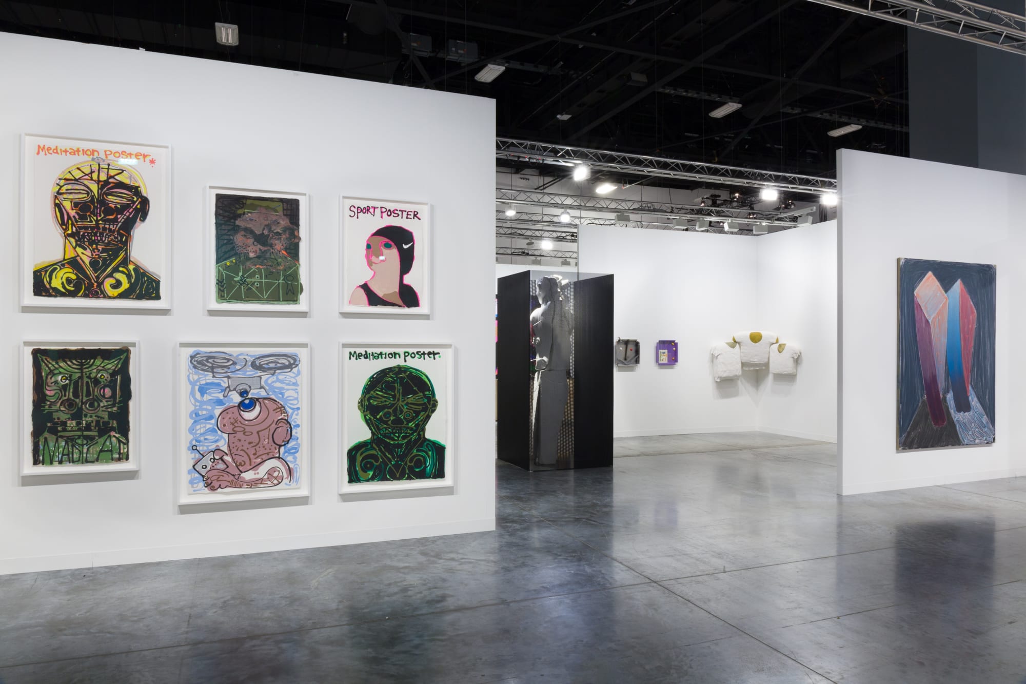 Installation views at Art Basel Miami Beach featuring paintings, sculptures, and more. Walls are white and works of art are colorful.