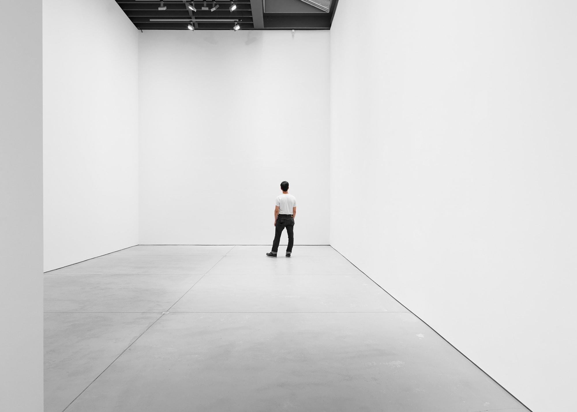Person gazing at the white wall.