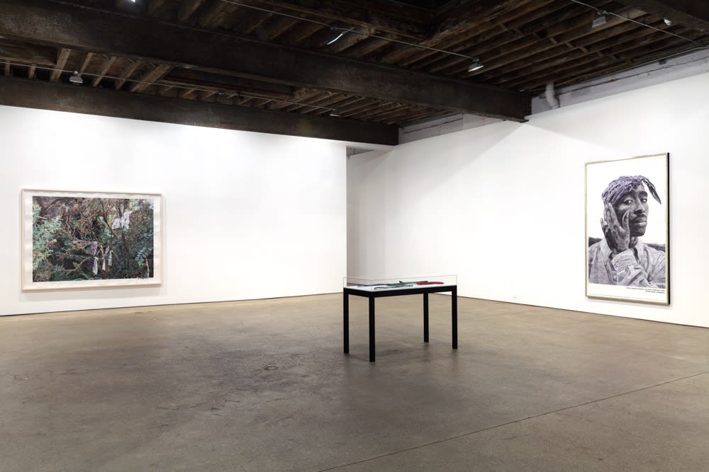 Installation view of Marcel Odenbach's seventh show at Anton Kern Gallery. Two additional works presented. Table of objects in the middle of the room.