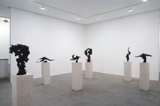 Installation view of Susan Inglett Gallery with several Eli Ping sculptures on wooden pedestals