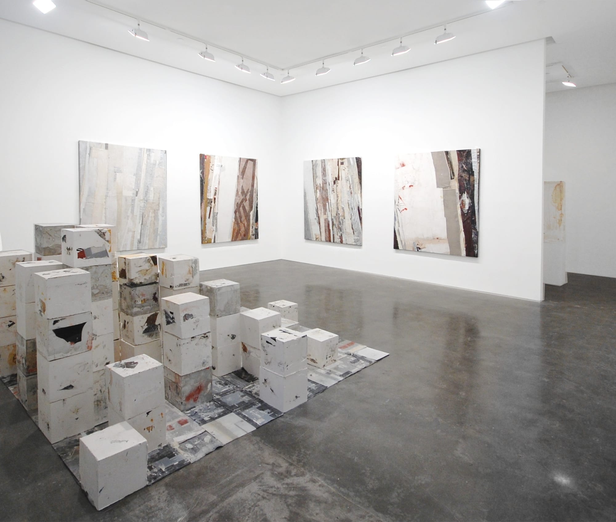 Installation view of four Ryan Wallace collaged artworks and a sculpture in his "Slo Crostic" exhibition at Susan Inglett Gallery