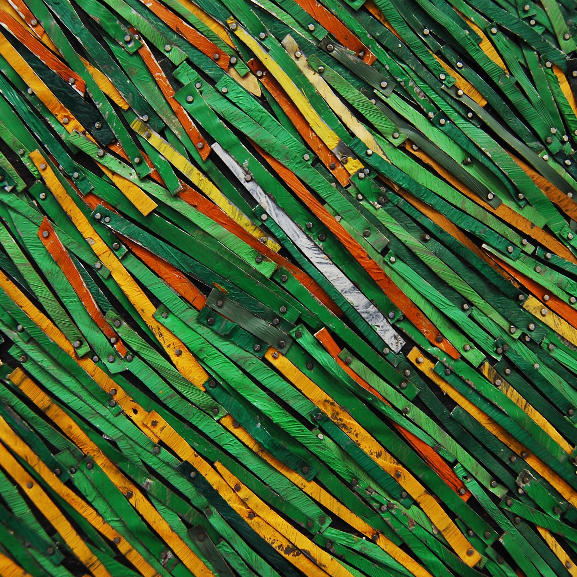 A detail of a Robert Kobayashi piece made from strips of colored tin