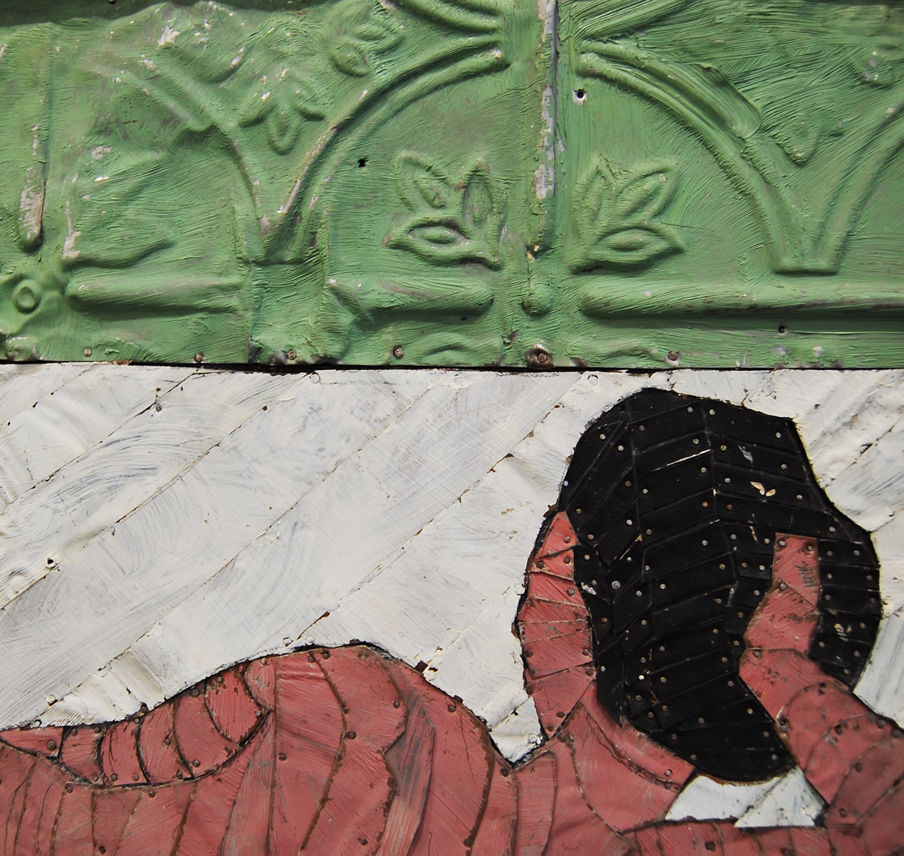 A detail of a nude by Robert Kobayashi rendered in colored strips of tin