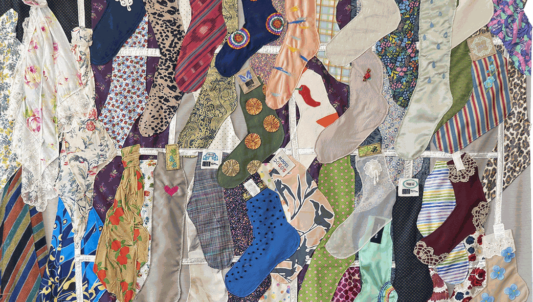 Detail view of a fabric quilt that depicts a sock stall in a South Korean market