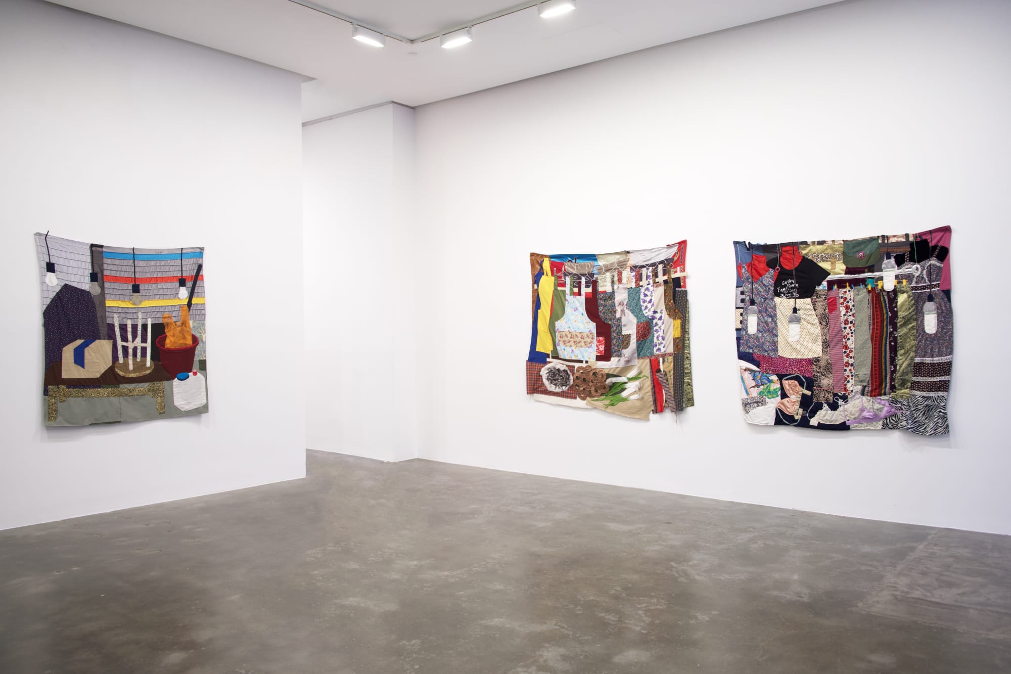 Installation view of three Woomin Kim quilts