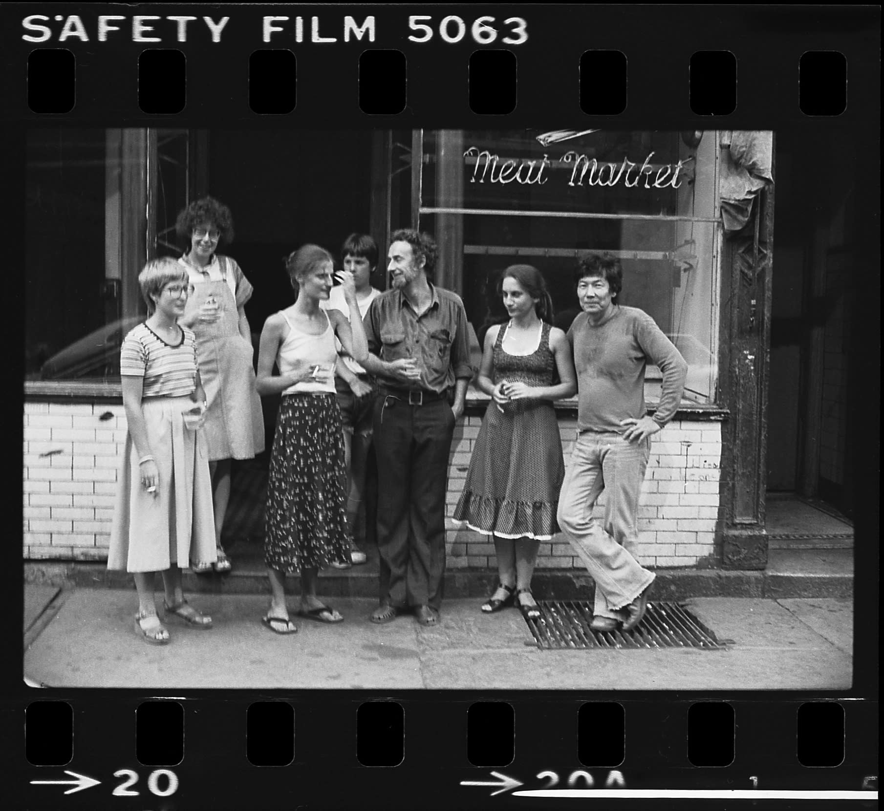 Black and white photo of Robert Kobayashi and friends outside Moe's Meat Market