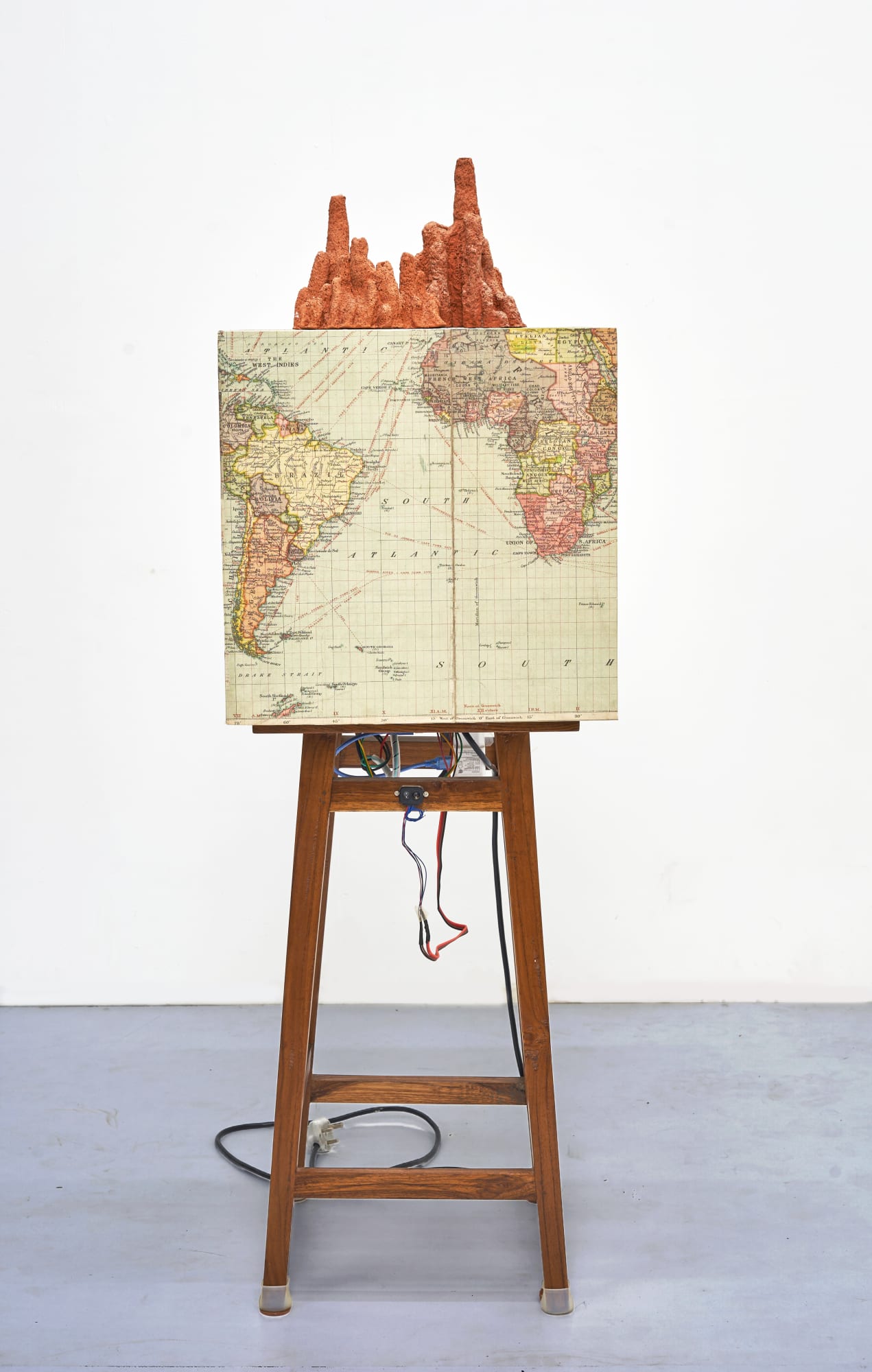 Shailesh B.R. The First Earthquake, 2015-2025 Kinetic sculpture , Concert vibrator, sensor, controllers, relay, power supply, Archival print and found Objects 53.25 x 16.25 x 16.25 in