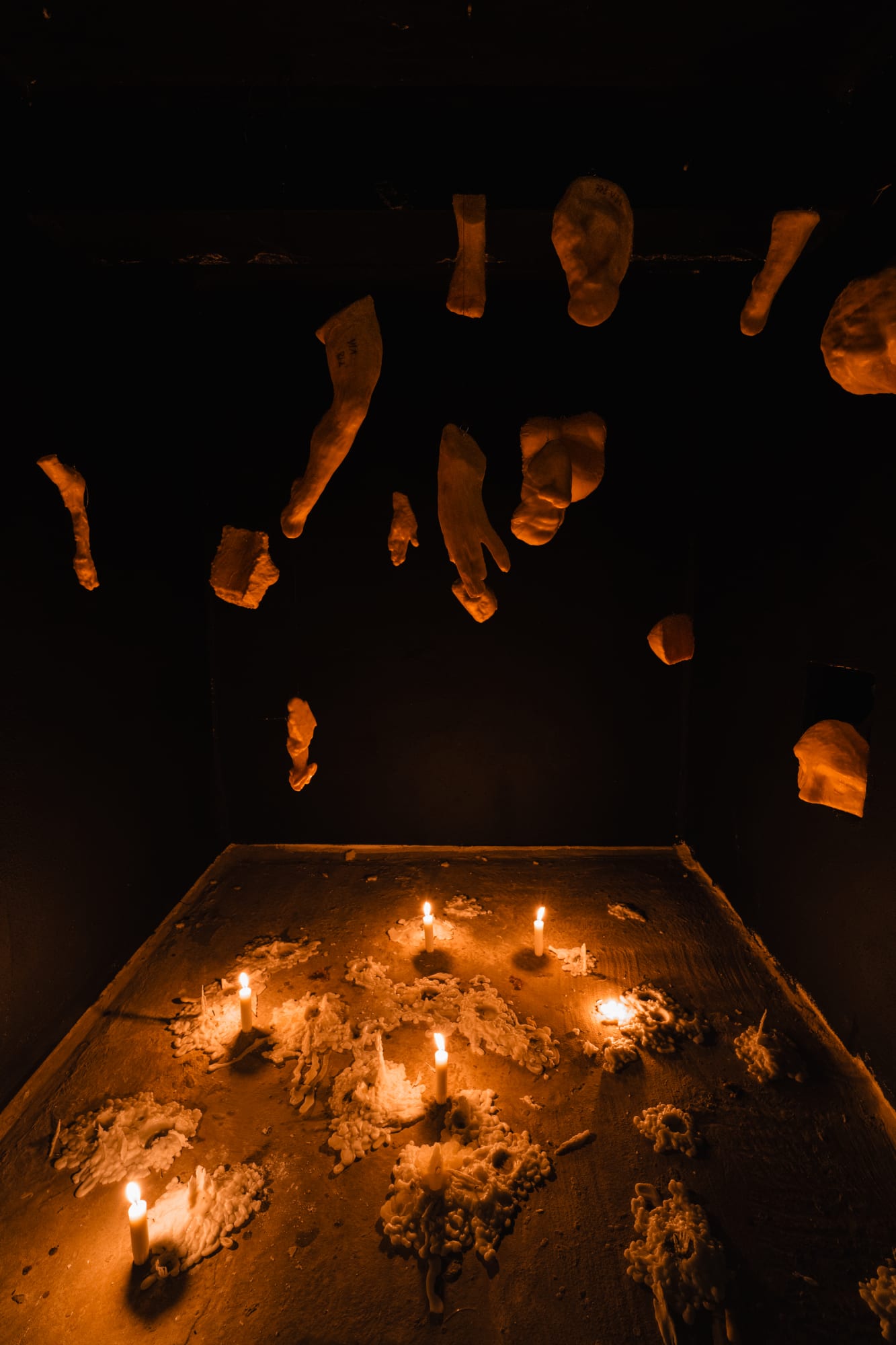 Phantom Votives, 2025, Beeswax, candles, sound by Dirar Kalash, Dimensions variable.