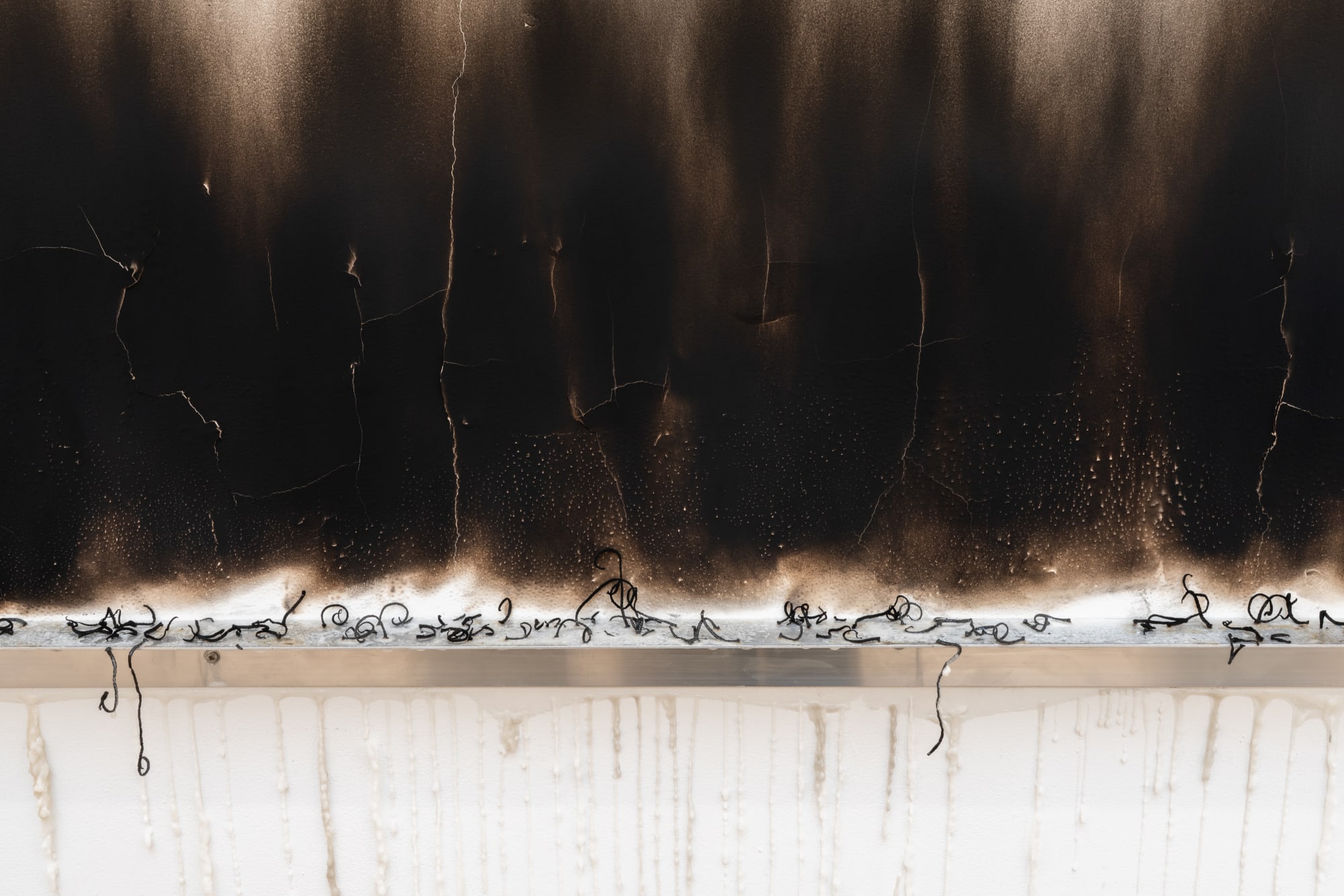 The Broken Burned Kilometer, 2025, Aluminum shelf, candle and fire on wall, Variable dimensions.