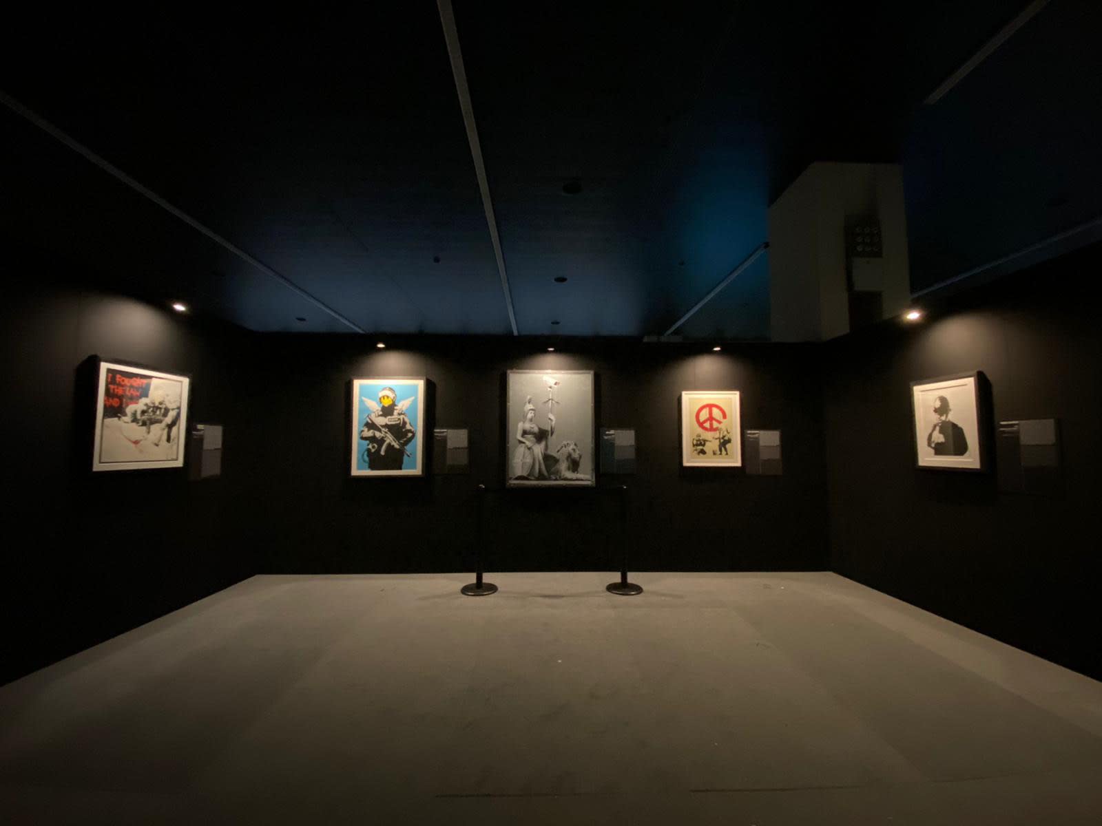 Banksy artwork hanging on wall