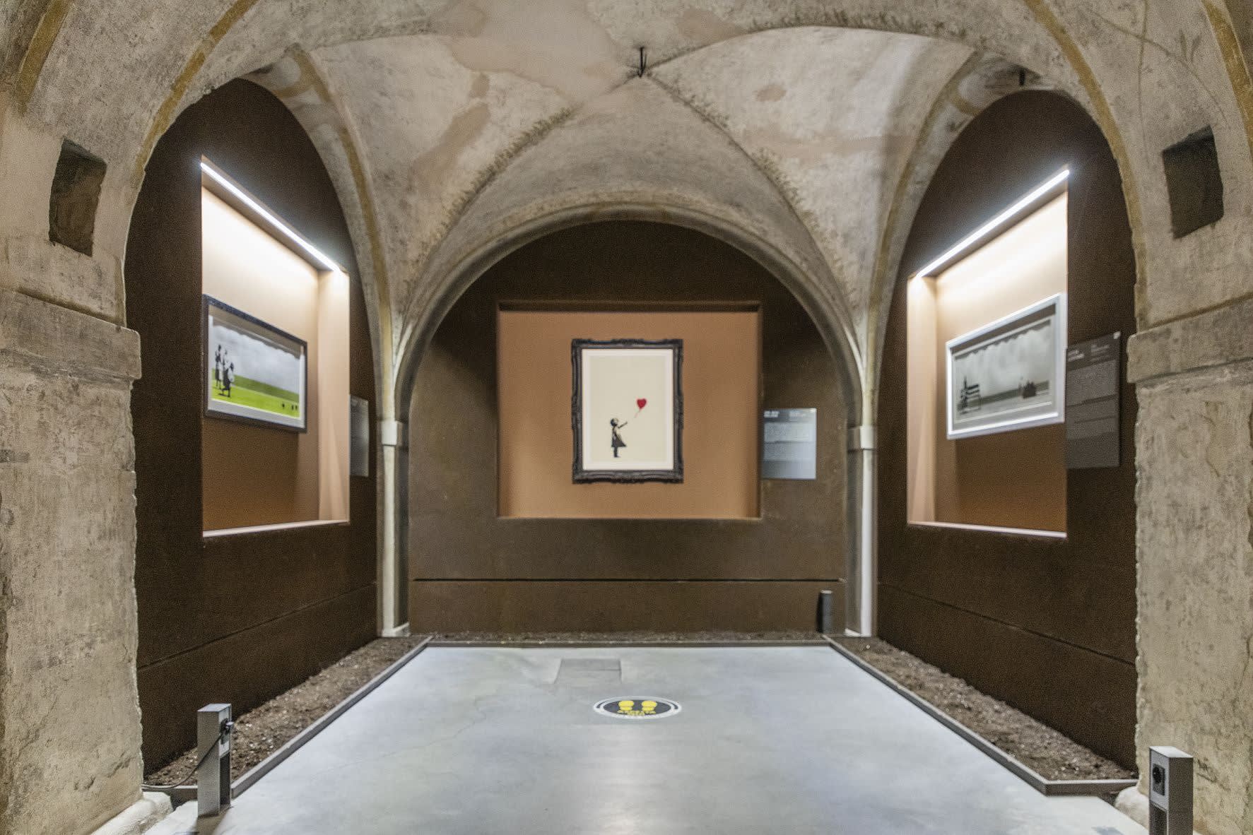 Banksy artworks hanging on wall