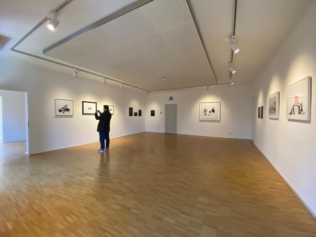 Banksy artworks hanging on wall