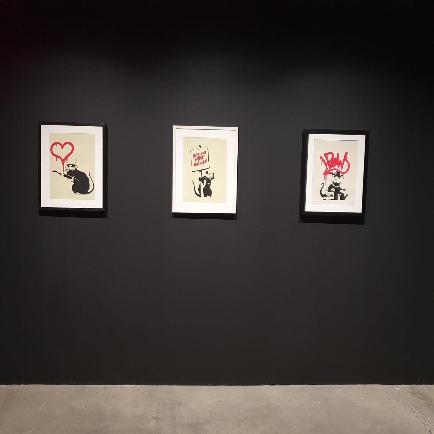 Banksy artworks hanging on wall