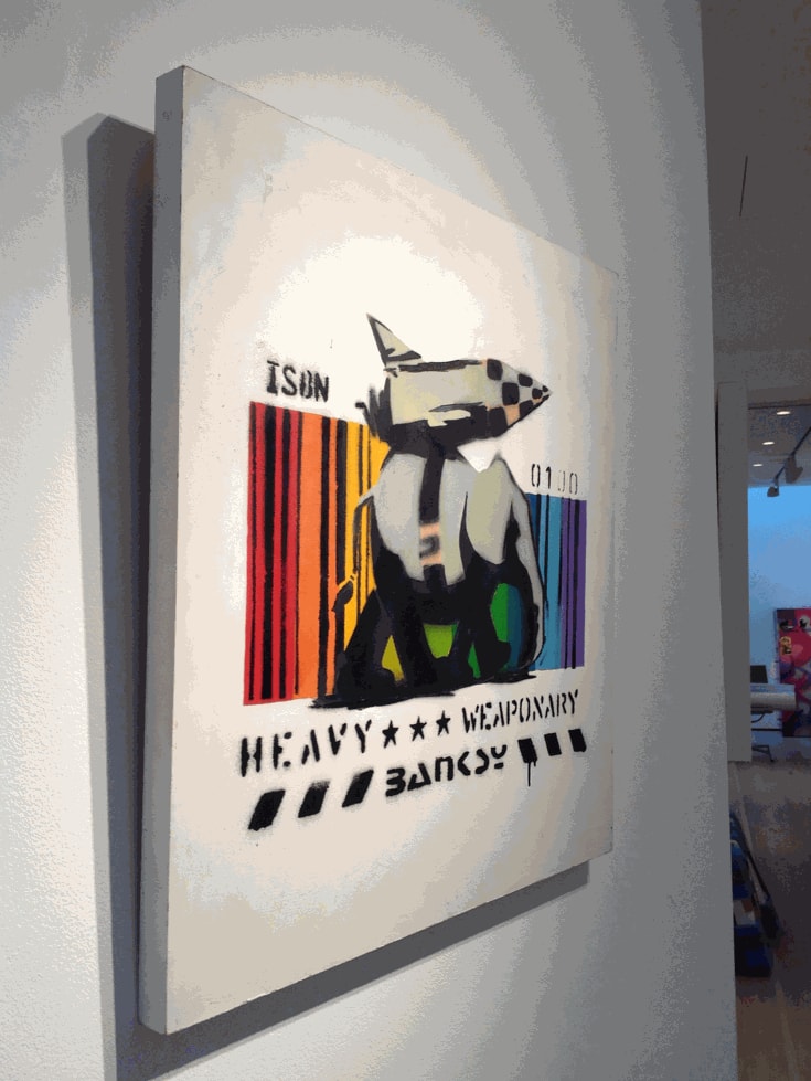 Banksy artwork hanging on wall