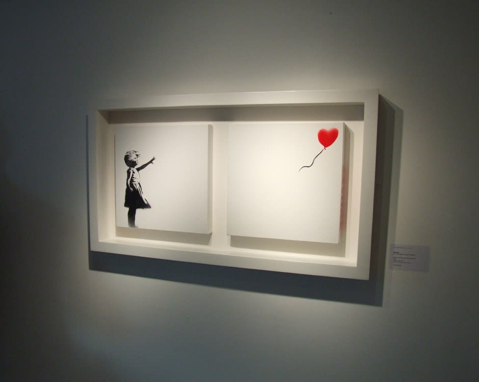 Banksy artwork hanging on wall
