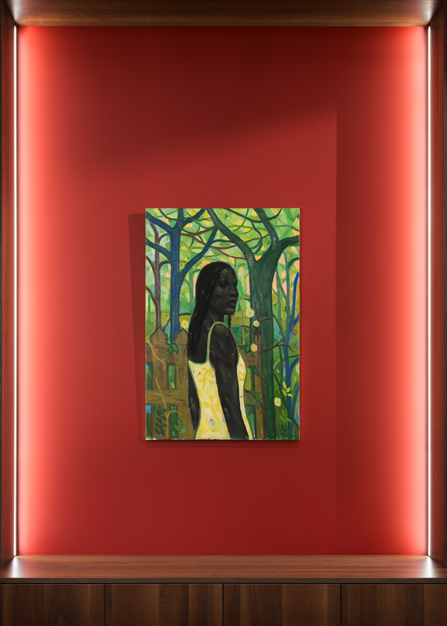 Exhibition view of A Song Beneath the Branches by Stephen Price at Galerie REVEL, showing a woman in a yellow dress surrounded by dense green foliage