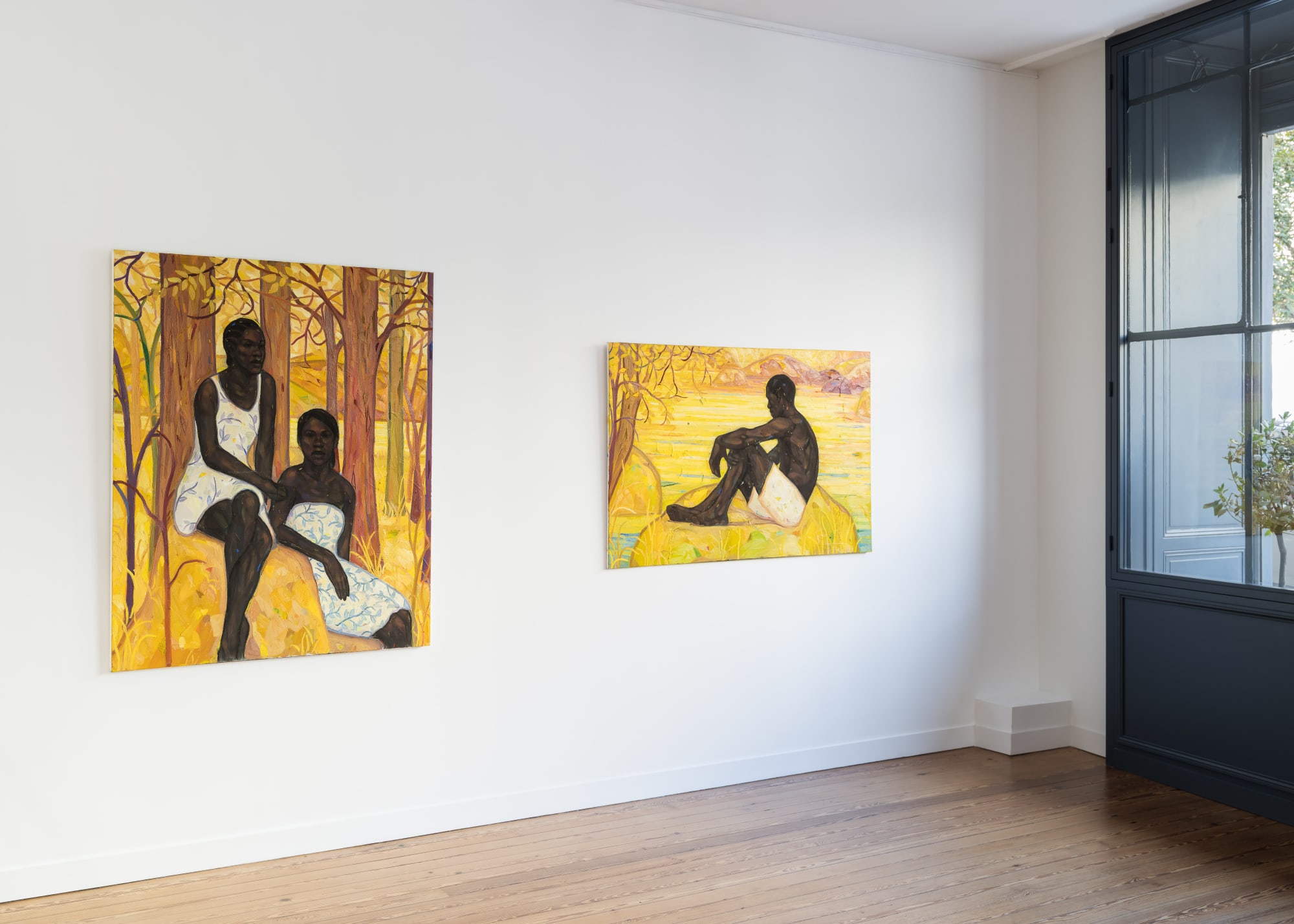 Exhibition view of figurative paintings by Stephen Price at Galerie REVEL, featuring portraits of Black figures in yellow forest landscapes