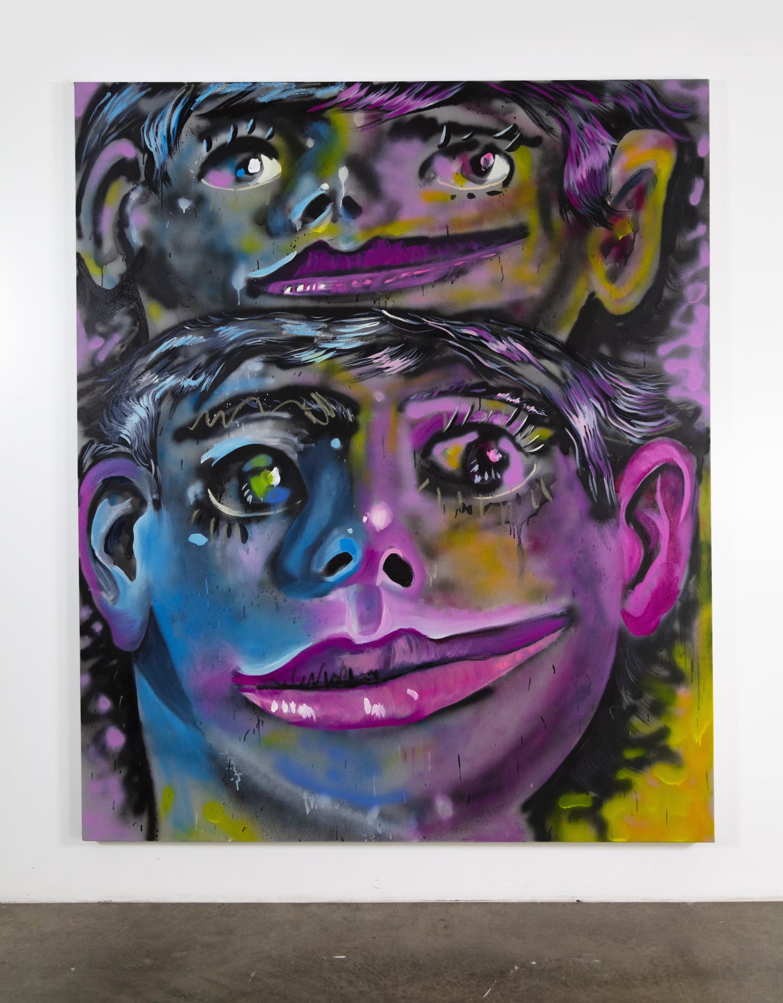 two heads mounted like a totem executed in neon like colors