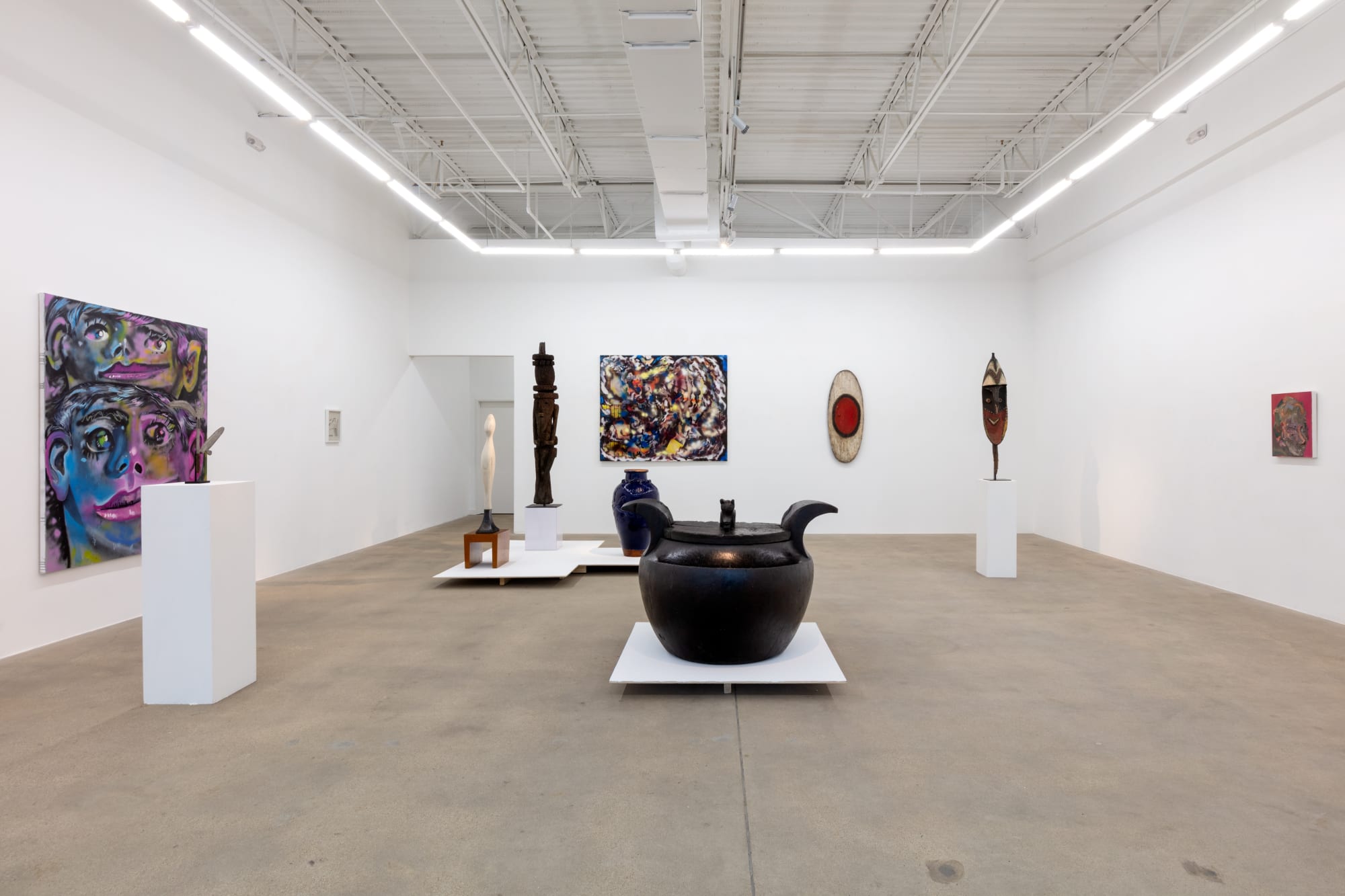 installation view of A Path Less Traveled, featuring historical ethnographic work and contemporary art