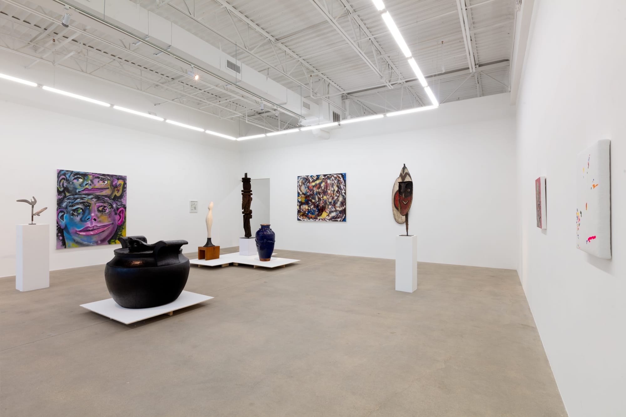 installation view of A Path Less Traveled, featuring historical ethnographic work and contemporary art
