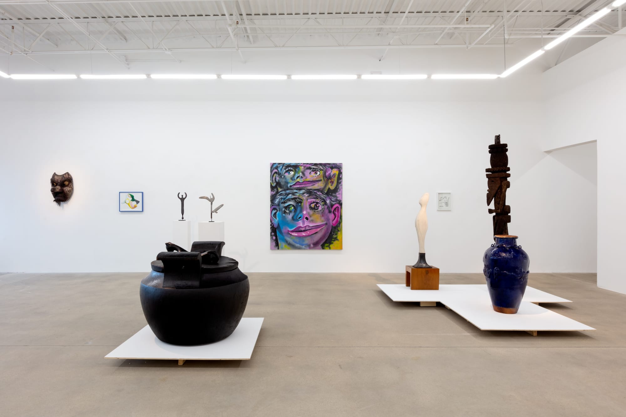 installation view of A Path Less Traveled, featuring historical ethnographic work and contemporary art