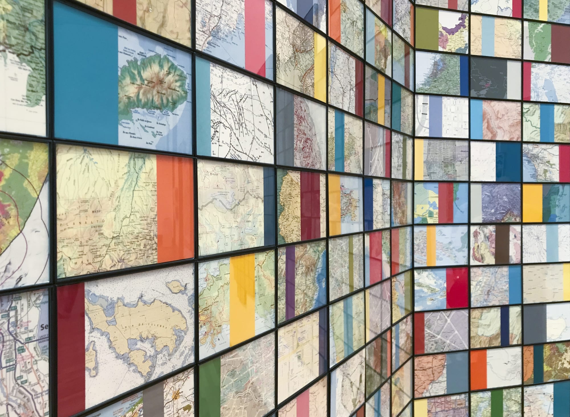 Nayda Collazo-Llorens Geo Dis/connect 3, 2017 Installation work with 360 framed collages with collected maps 4 x 6 inches each tablet, Total dimensions approx. 5 x 16 ft