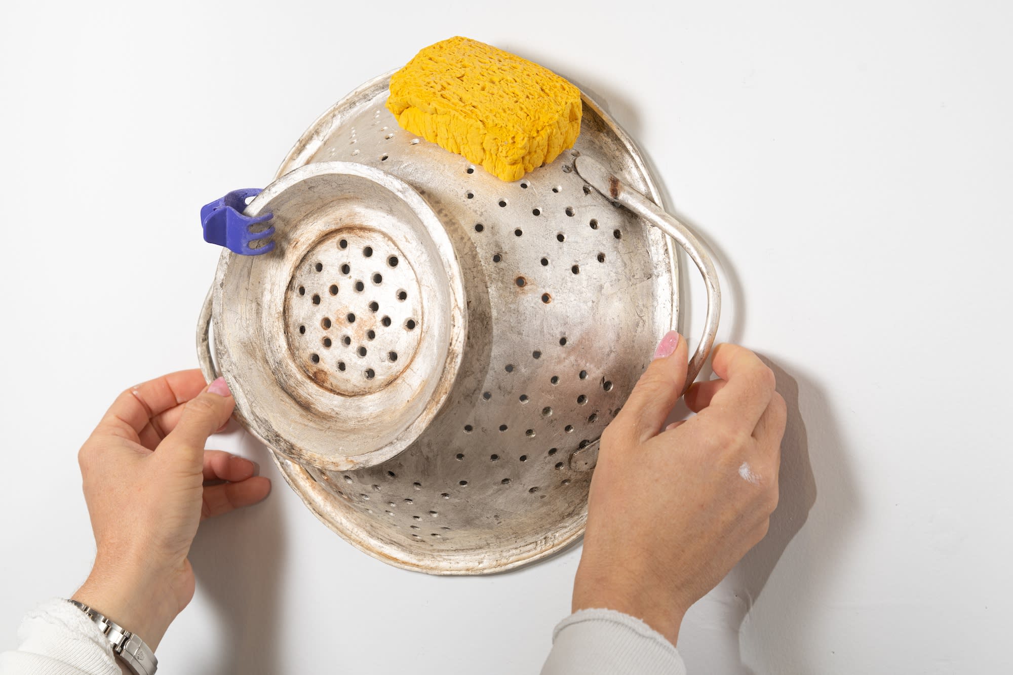 colander being held up by two hands