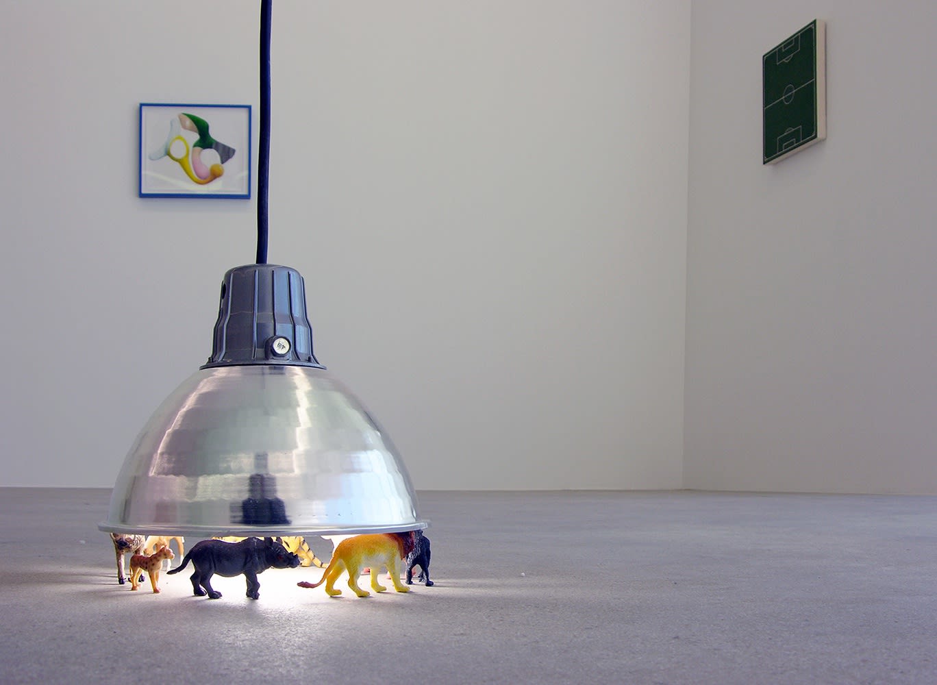 Installation view of Murmur, two works on the wall and a lamp sculpture on the front end.