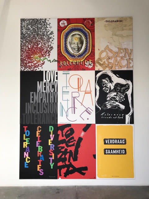 Display of posters, including the artist's work "Friends Not Food," at the Tolerance Poster Show in Dubai