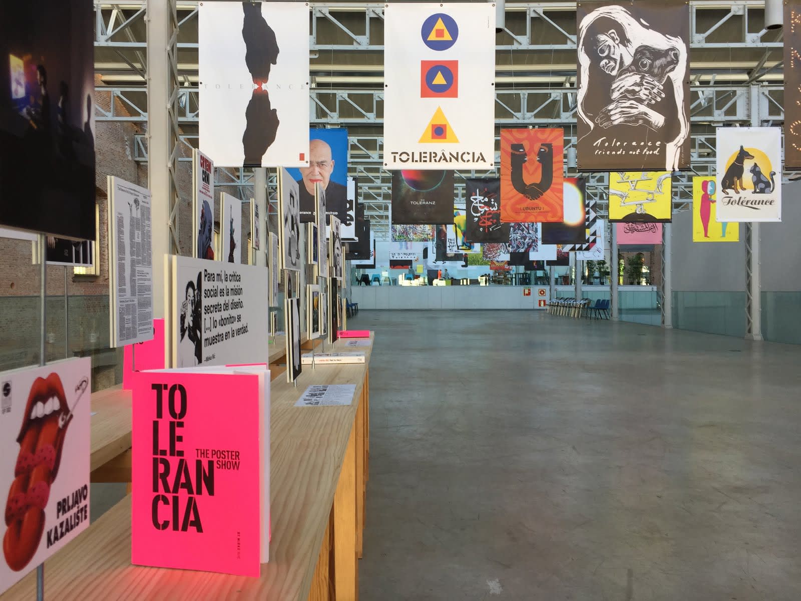 Exhibition installation of posters, including the artist's work "Friends Not Food," at the Tolerance Poster Show in Madrid