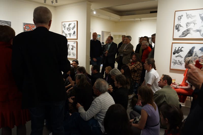 Photograph of people crowded into a room for the opening night of the exhibition "Mad As Hell!: New Work (and Some Classics) by Sue Coe," April 17, 2012 — July 03, 2012