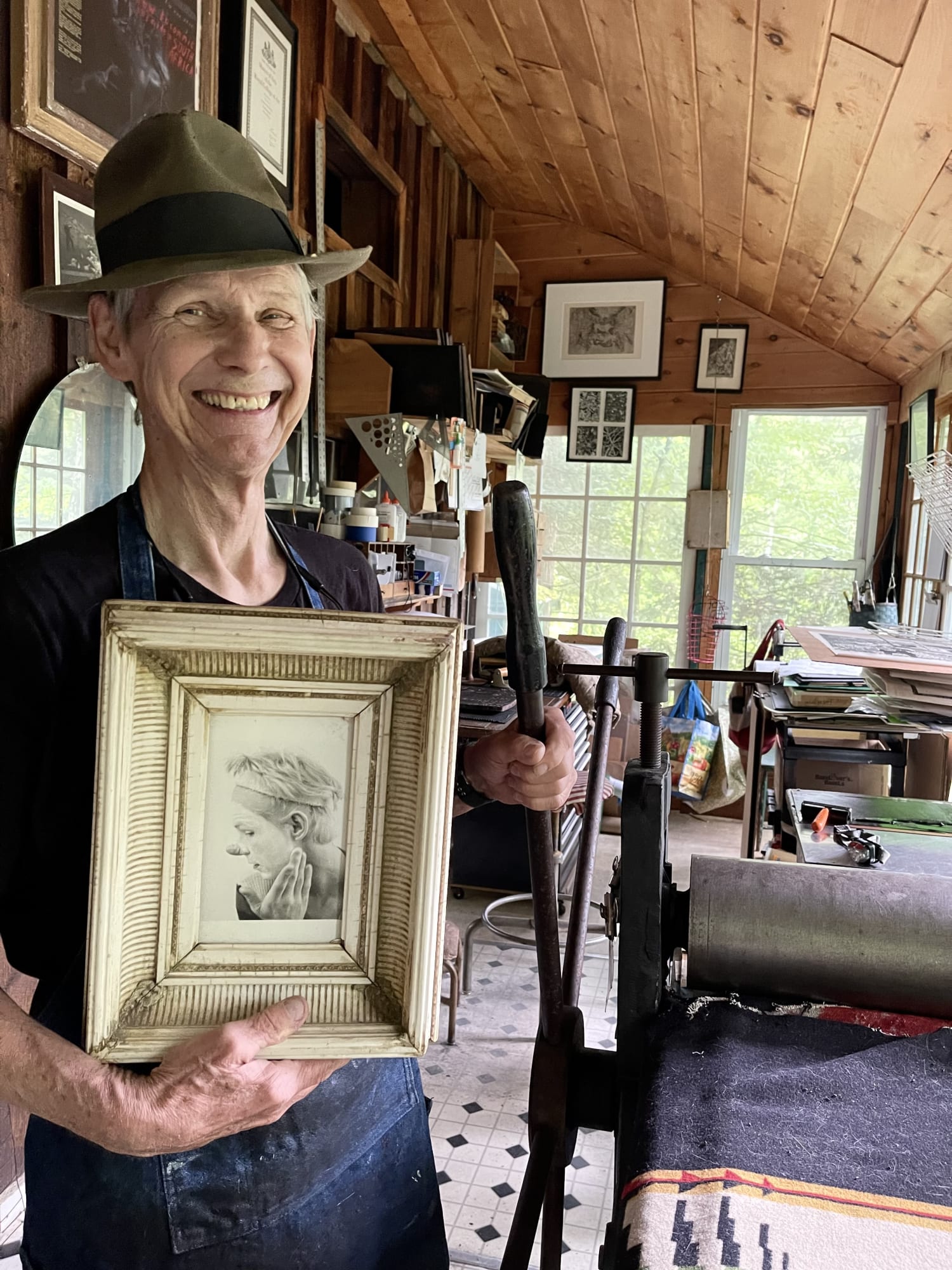 Photograph of Steve Murray holding a picture of himself wearing circus makeup, ca. 1970s