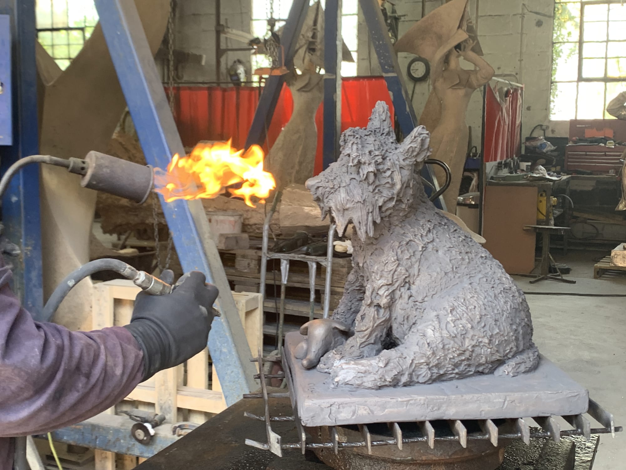 Heating the bronze to apply the patination colour.