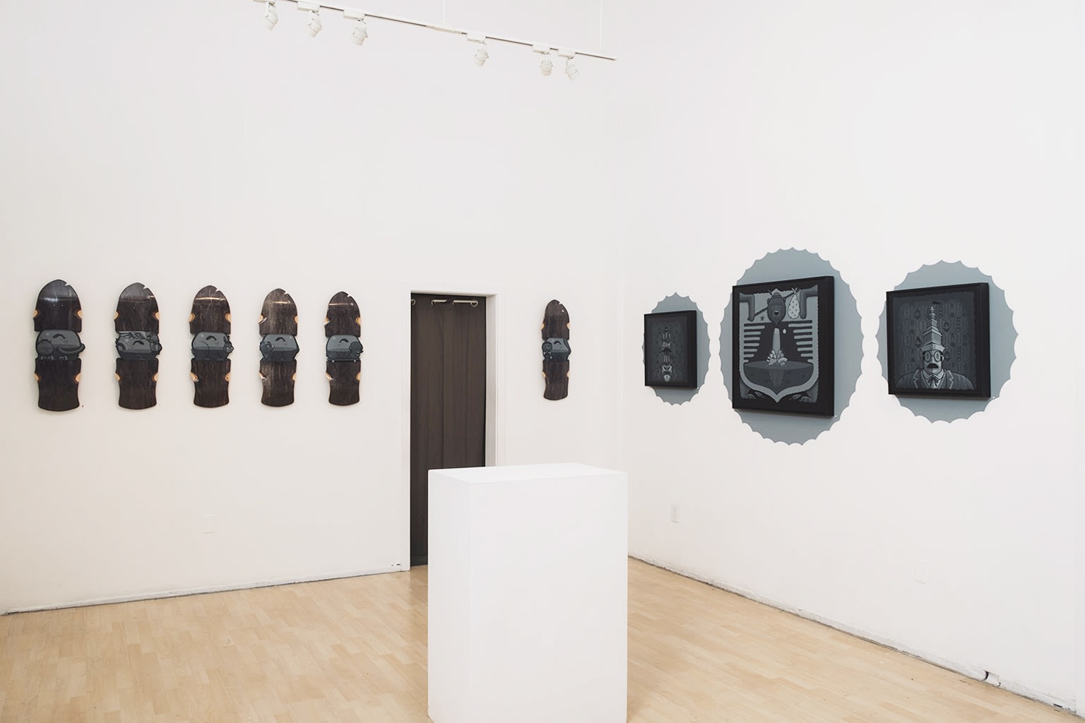 blue-grey toned Jeremy Fish work installed on a white wall