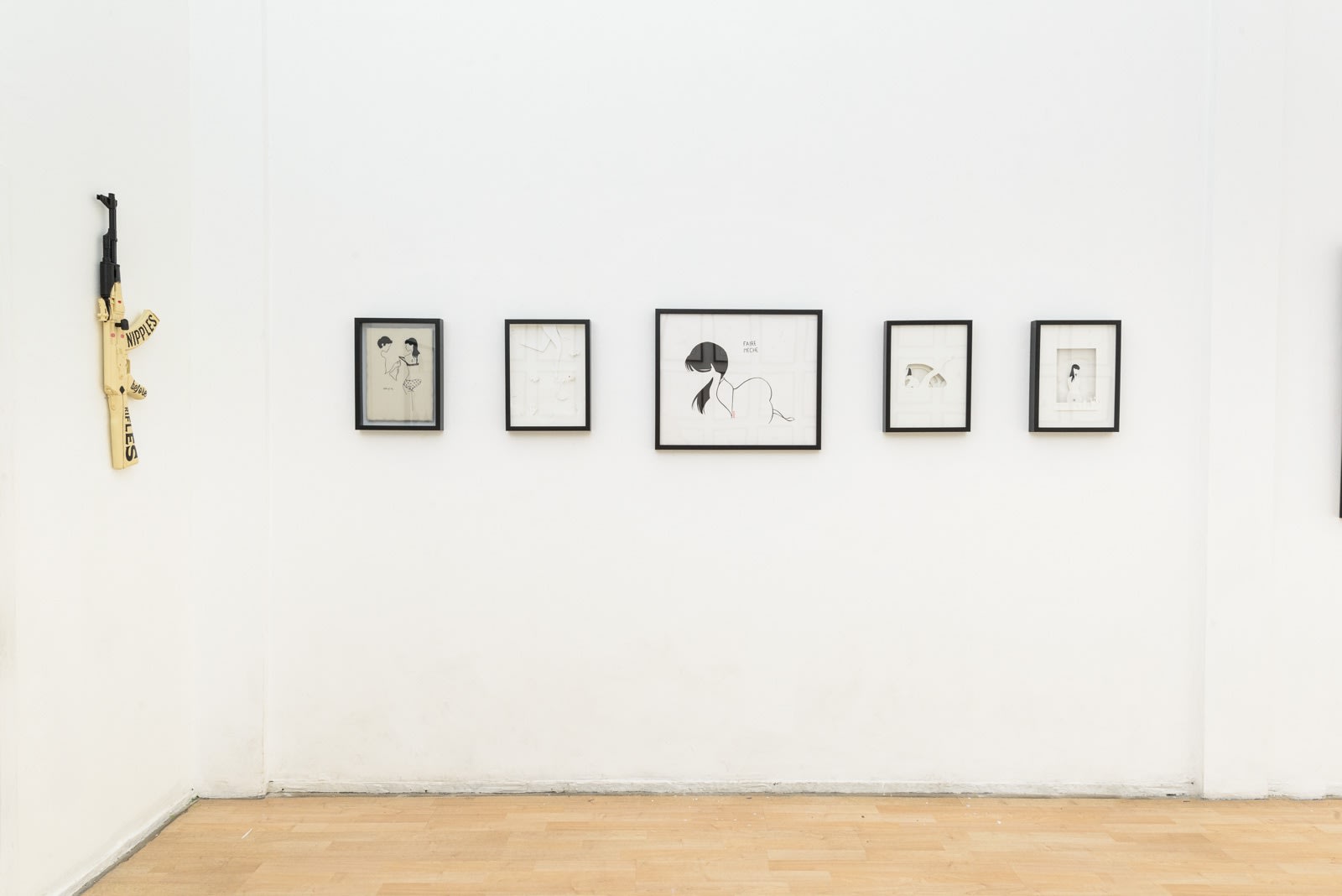 Install photo of framed illustrations by Petite Luxures hung on a wall