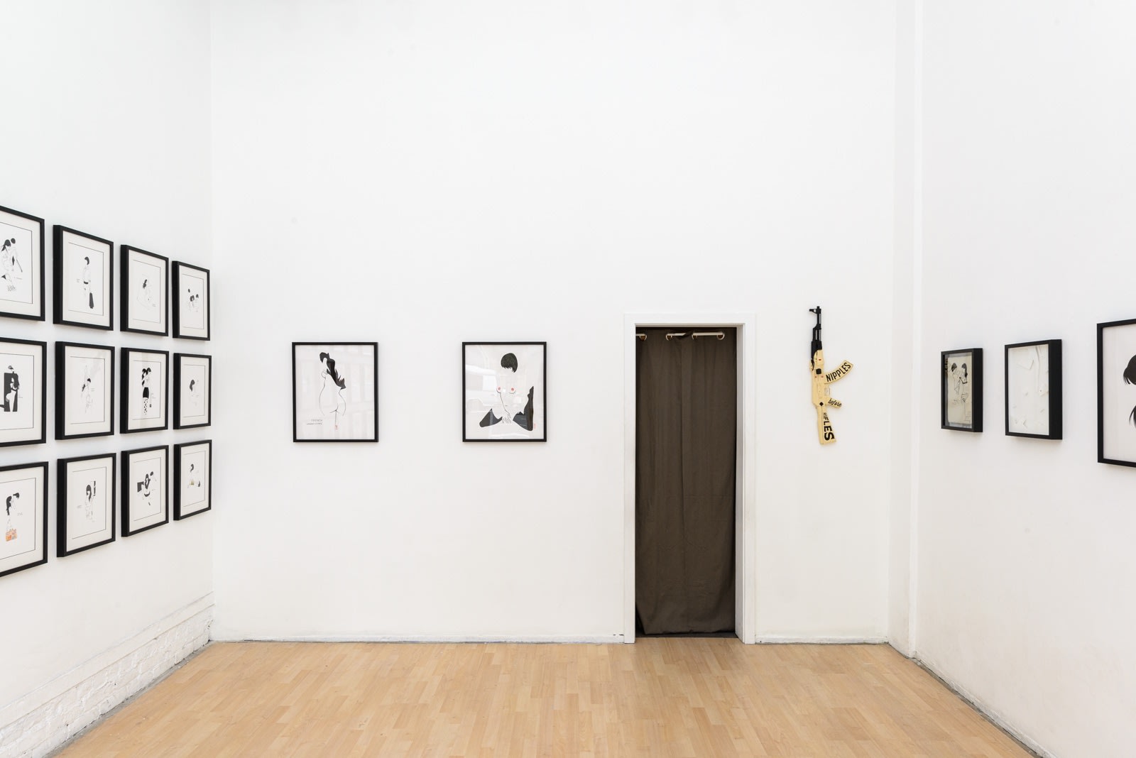 Install photo of framed illustrations by Petite Luxures hung on a wall