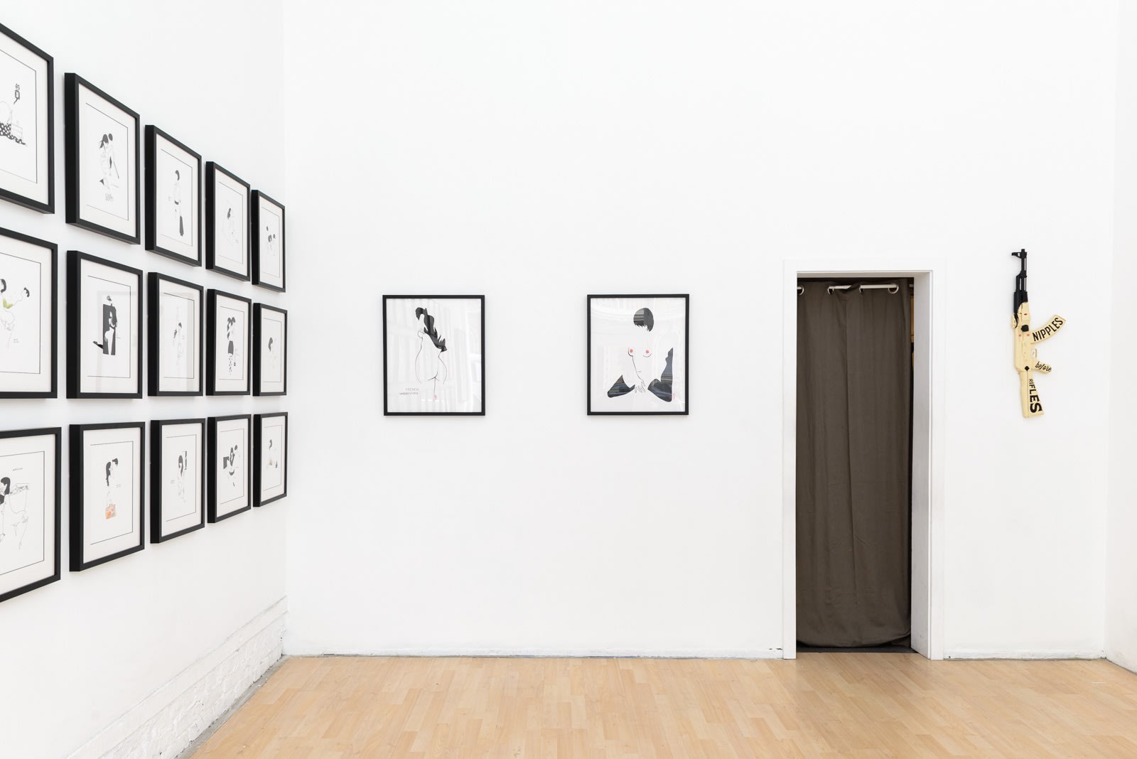 Install photo of framed illustrations by Petite Luxures hung on a wall