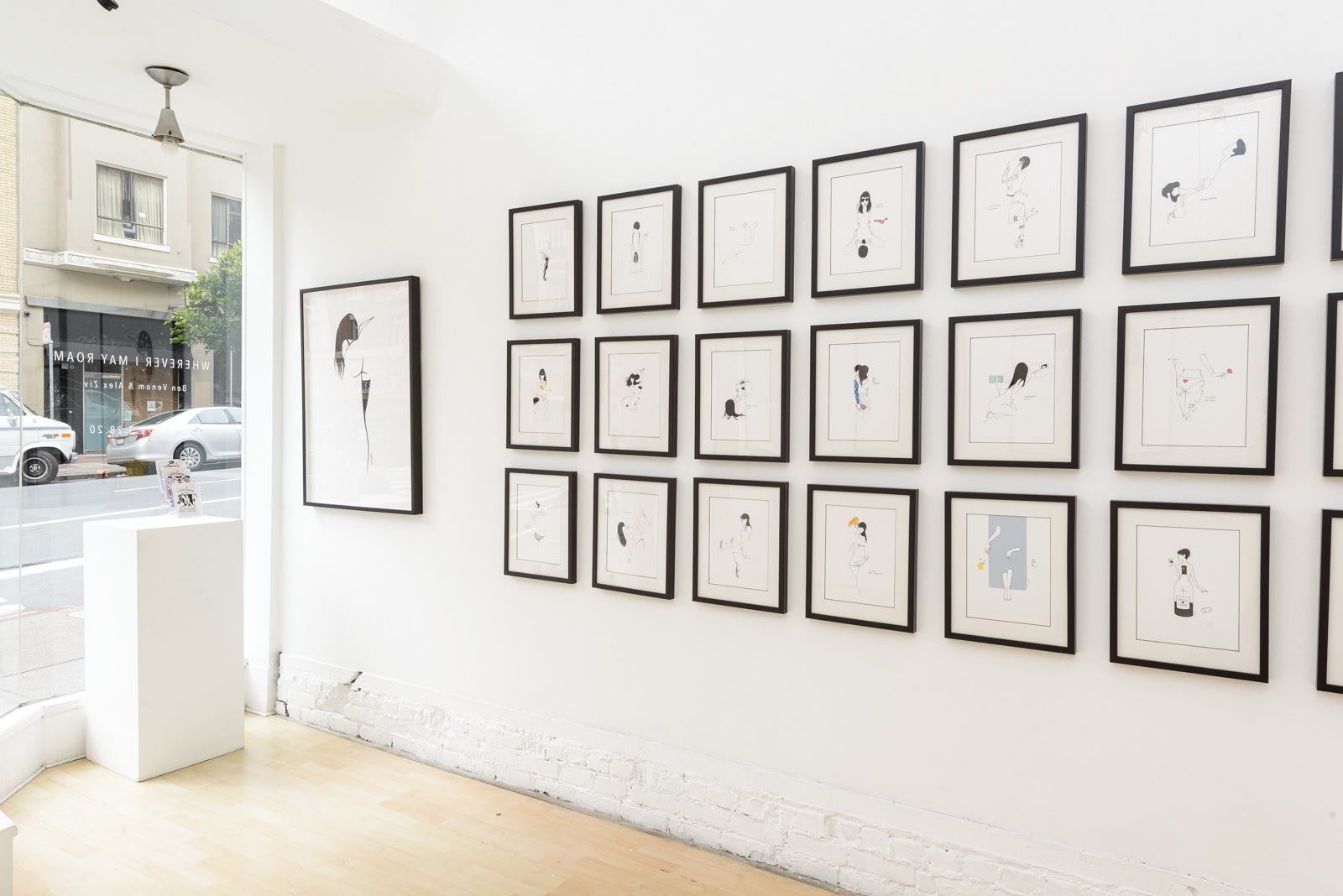 Install photo of framed illustrations by Petite Luxures hung on a wall