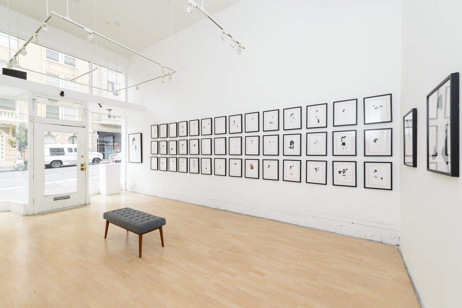 Install photo of framed illustrations by Petite Luxures hung on a wall