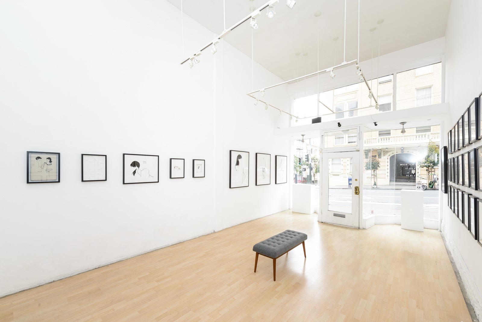 Install photo of framed illustrations by Petite Luxures hung on a wall
