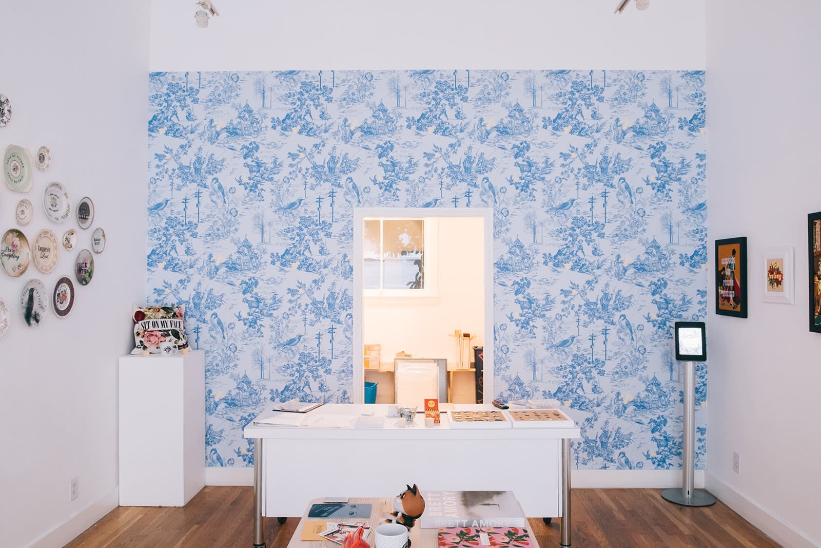 Install shot of decorative plates hung on a wall as part of MC Marquis exhibition