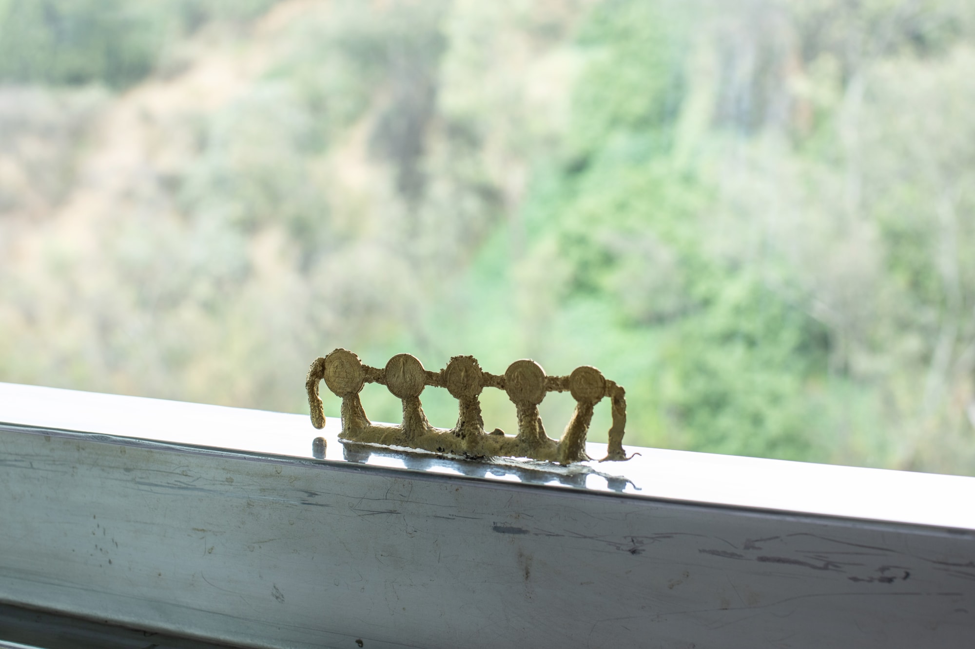 Tania Pérez Córdova Contenidos de un bolsillo: 7 coins 1 key, 2021 Bronze 5 x 20 x 2 cm (2 x 7.9 x 0.8 in)