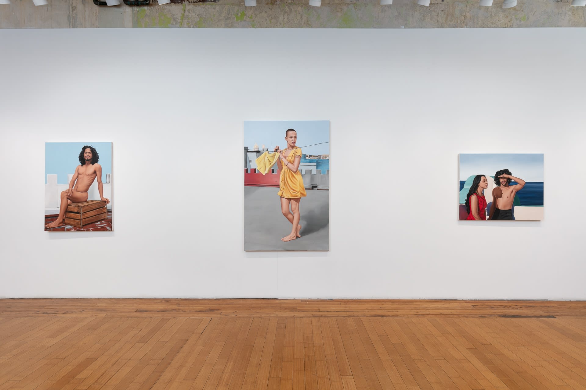 Installation shot of a group of works on the right wall of the gallery. From left to right: Luis on an Empty Box, Hung Up to Dry, and Seeking Freedom.
