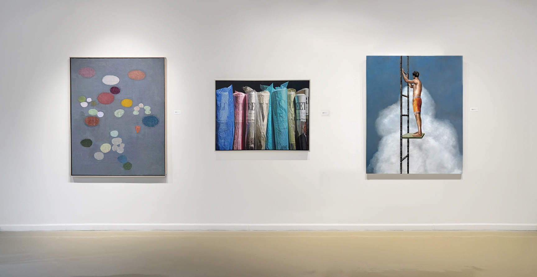 installation view gallery interior with three paintings