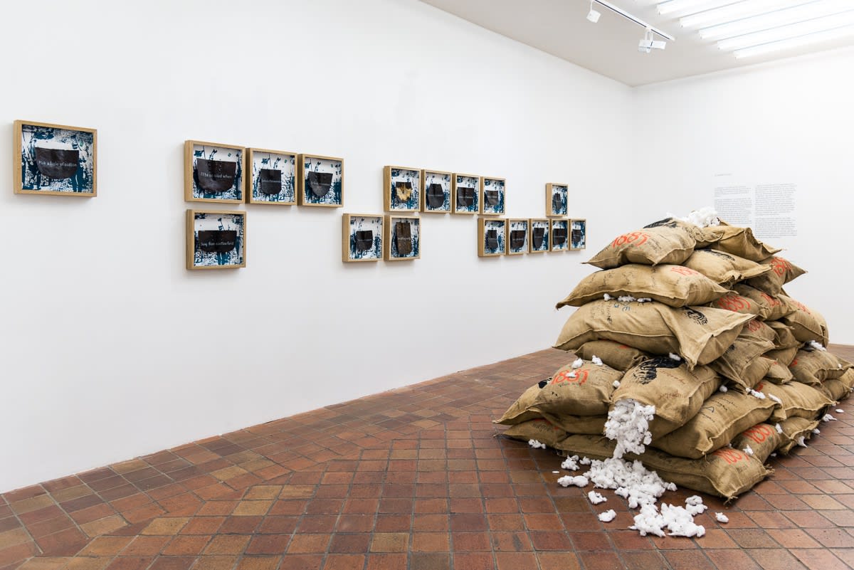 View of the installation Le chemin de fer by Jean David Nkot featuring the figure of Harriet Tubman printed on jute bags