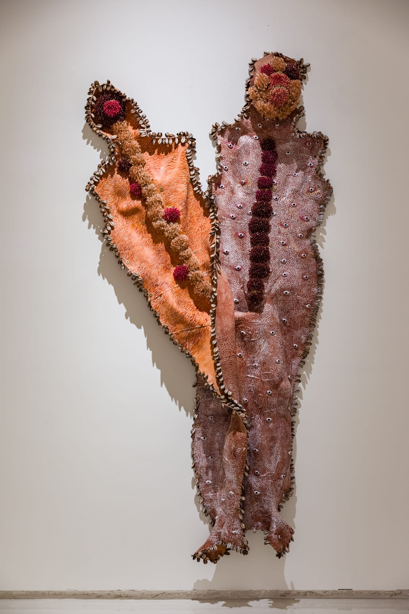 Debashish Paul (b.1994) Shells of Past Life 2 Latex rubber, cowrie shells, acrylic ink, crystal and plastic beads, threads, stone eyes, and brass washer 76.7 x 40.1 in. 2024, Varanasi